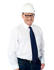 Image showing Handsome smiling aged engineer with hard hat