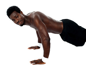 Image showing Handsome fit shirtless man doing pushups