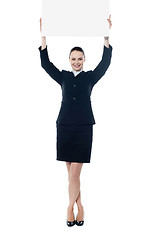 Image showing Young businesswoman holding a blank signboard