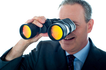 Image showing Senior man observing through binoculars