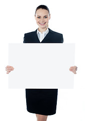 Image showing Businesswoman holding a blank white poster