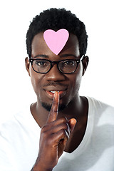 Image showing Man with pape heart on forehead gesturing silence