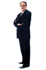 Image showing Aged company manager posing with folded arms