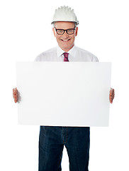 Image showing Businessman architect holding a blank white signboard