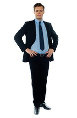 Image showing Full length view of a young businessperson posing with hands on his waist