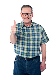 Image showing Casual old man showing thumbs-up sign to camera