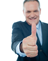 Image showing Smiling matured businessman showing thumbs-up