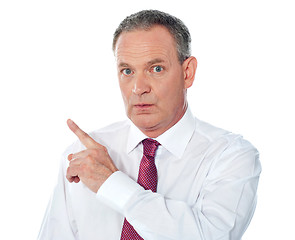 Image showing Portrait of senior businessman pointing backwards