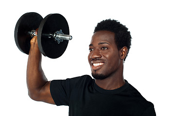 Image showing Powerful muscular young man lifting weights