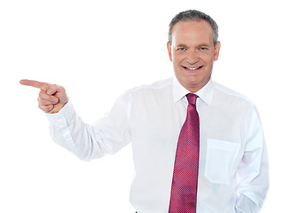 Image showing Old caucasian male executive pointing away