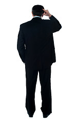 Image showing Rear view of corporate person thinking