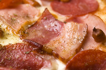 Image showing Italian pizza with bacon, salami and mozzarella cheese