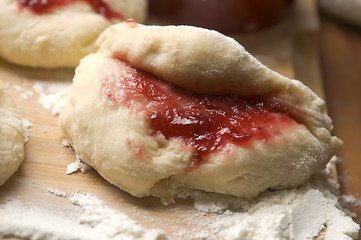 Image showing Dough with marmelade on wooden board