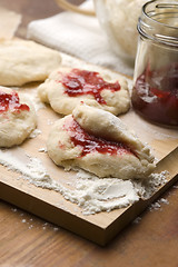 Image showing Dough with marmelade on wooden board