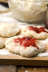 Image showing Dough with marmelade on wooden board