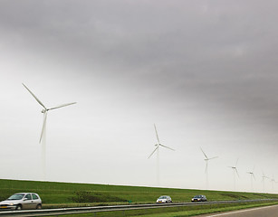 Image showing Wind turbines and car on highway