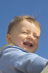 Image showing baby smiling over blue sky