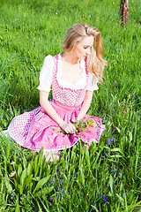 Image showing young woman with pink dirndl outdoor