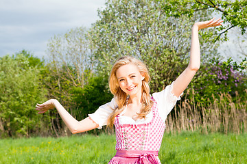 Image showing young woman with pink dirndl outdoor