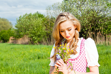 Image showing young woman with pink dirndl outdoor