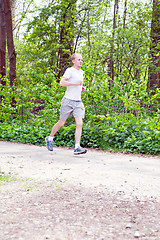 Image showing man is jogging in the forest