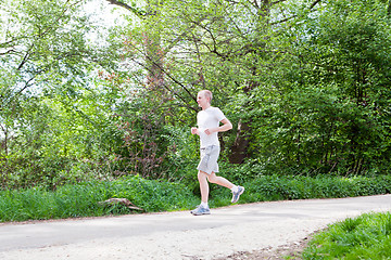 Image showing man is jogging in the forest