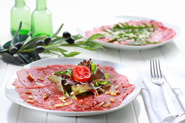 Image showing Carpaccio with salad and pine nut