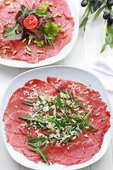 Image showing Carpaccio with arugula and cheese