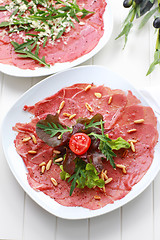 Image showing Carpaccio with salad and pine nut