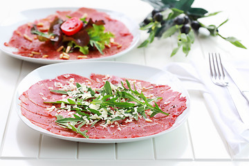 Image showing Carpaccio with arugula and cheese