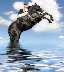 Image showing rearing horse in the water