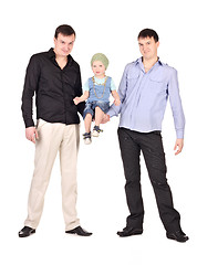 Image showing Two guys hold little boy 