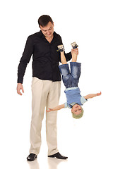 Image showing Man holds little boy upside down