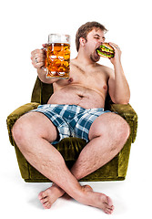 Image showing fat man eating hamburger