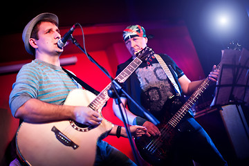 Image showing musician plays a guitar