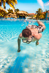 Image showing teenager floats in pool