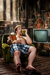 Image showing fat man eating hamburger