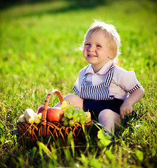 Image showing little boy with a basket of fruit