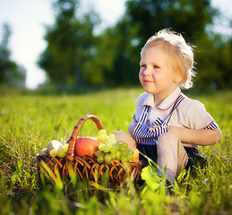 Image showing little boy with a basket of fruit