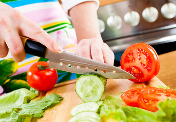 Image showing Woman's hands cutting vegetables