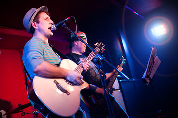 Image showing musician plays a guitar