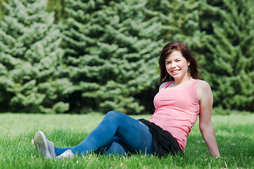 Image showing Young happy girl lying on grass