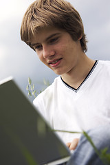 Image showing Boy with notebook on the field