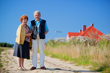 Image showing Happy senior couple and house