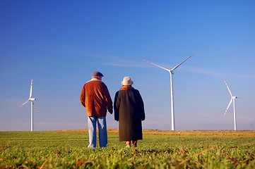 Image showing Seniors' couple and wind turbines