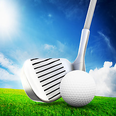 Image showing Playing golf. Ball on tee, a golf club