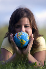 Image showing Pretty girl watching earth globe