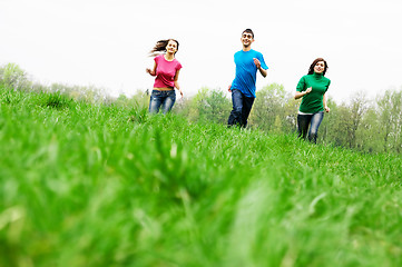 Image showing Happy friends jumping