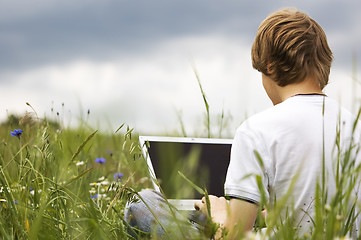 Image showing Boy with notebook on the field