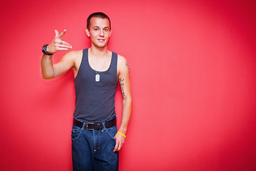 Image showing Young handsome man on red wall